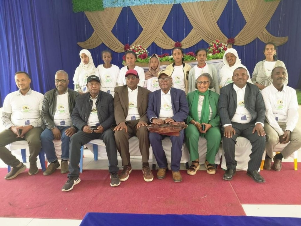 Partners and community leaders standing together for peace and development.